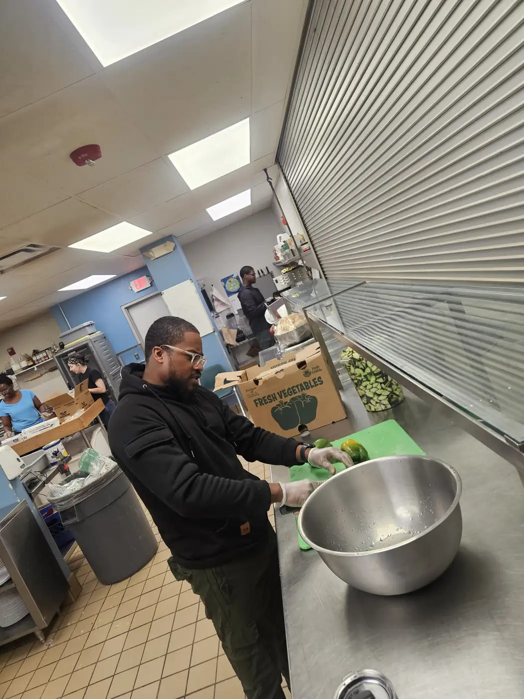 Darell Brown helping prepare food in a community kitchen