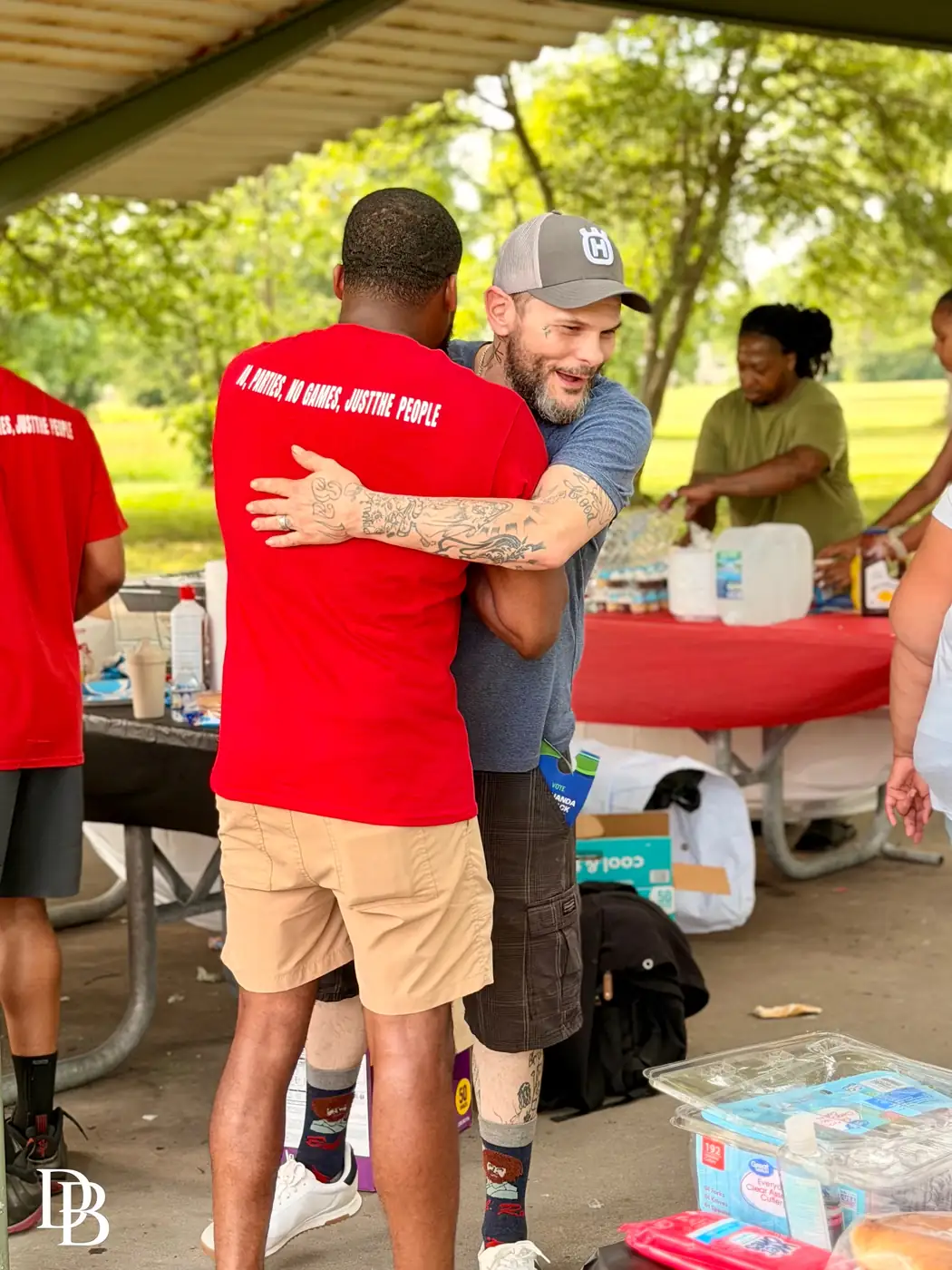 Darell Brown serving food alongside community volunteers