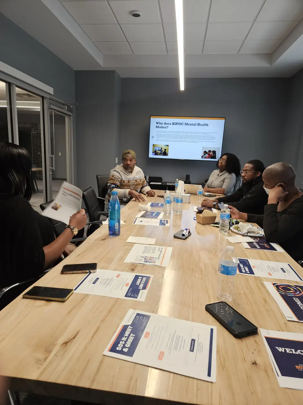 Darell Brown meeting with residents around a conference table
