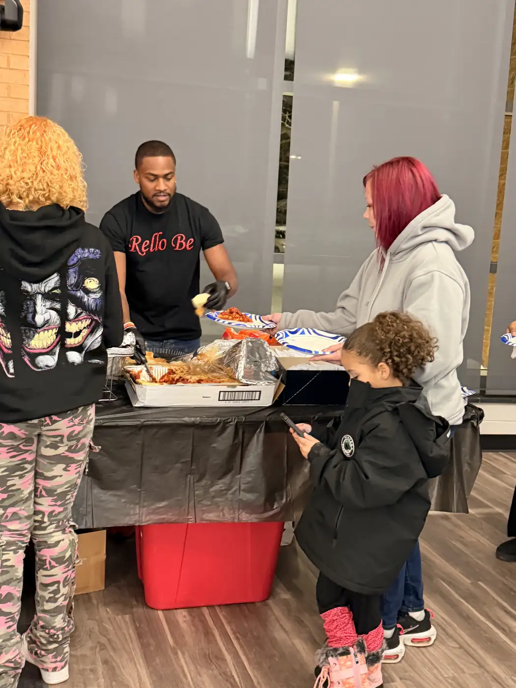 Darell Brown preparing food with families and volunteers