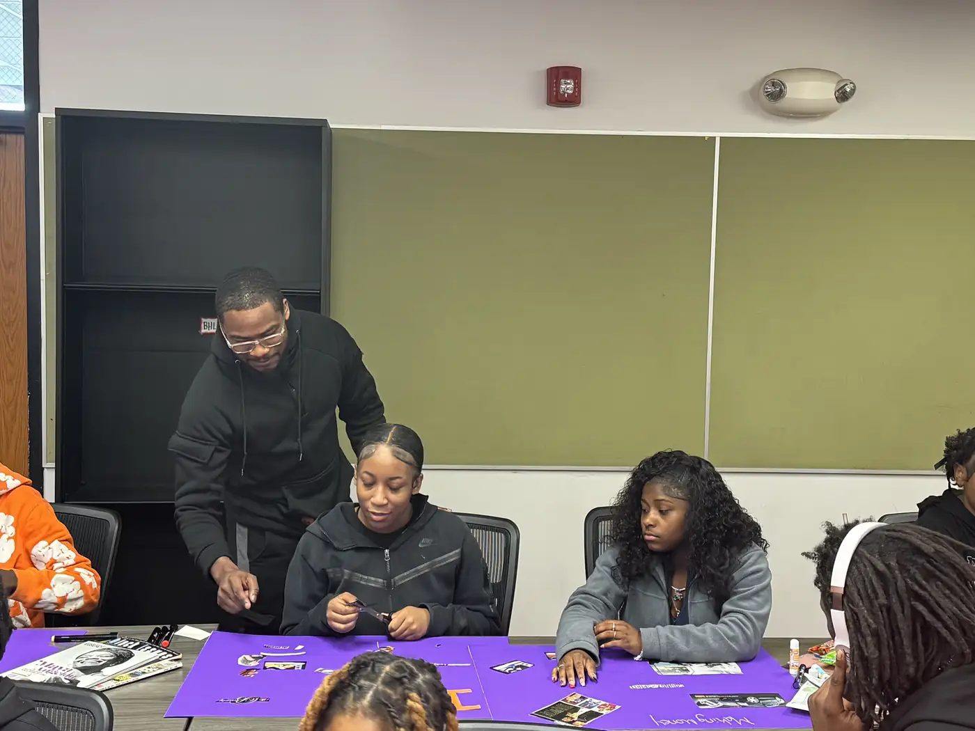 Darell Brown supporting a youth activity at a community table