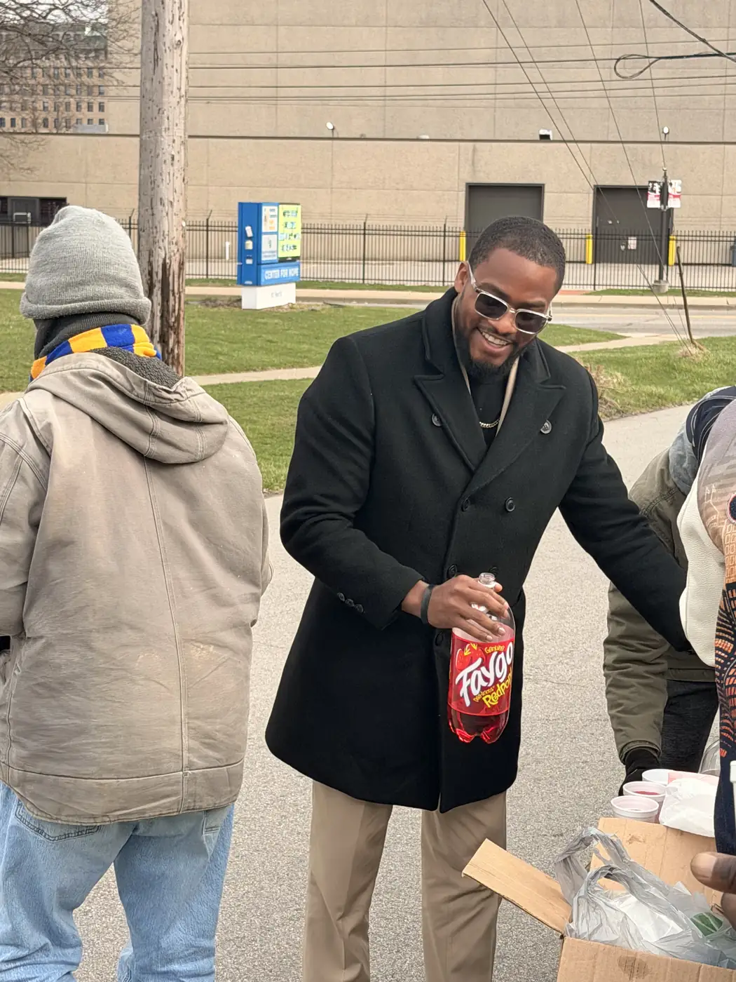Darell Brown serving neighbors at an outdoor food event