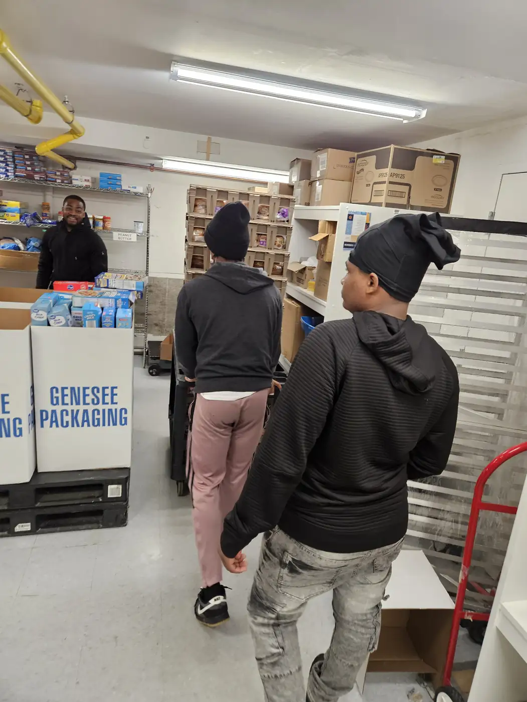 Darell Brown mentoring a young volunteer in the kitchen